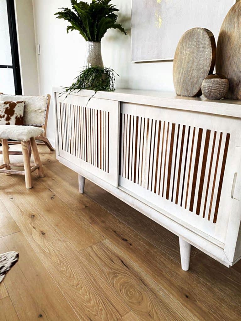 Living room cabinet with pottery and plants on top